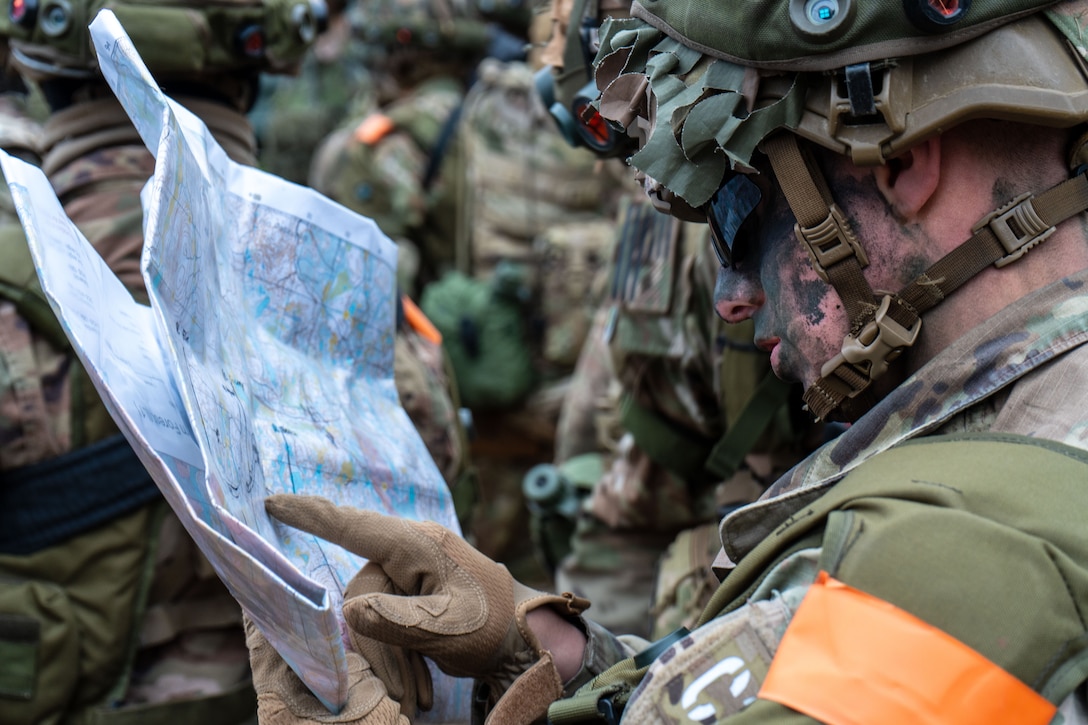 A soldier looks at a map.