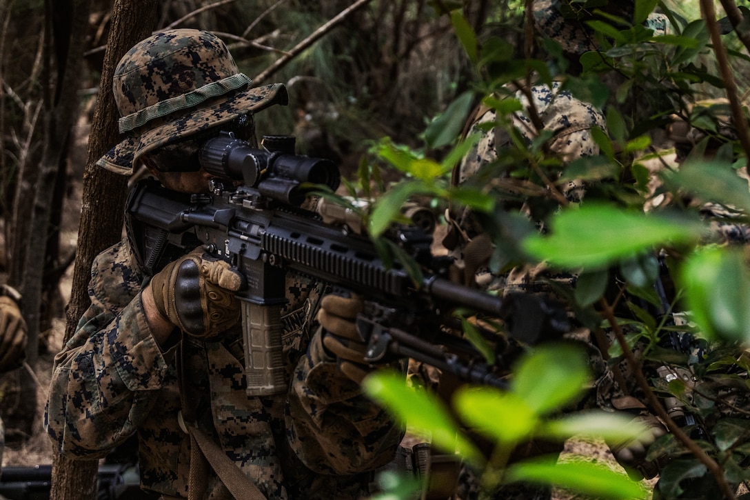 U.S. Marine Corps Lance Cpl. Hunter Ross, an infantry Marine with 3rd Littoral Combat Team, 3rd Marine Littoral Regiment, 3rd Marine Division, posts security with an M27 Infantry Automatic Rifle during a patrol at Kahuku Training Area, Hawaii, June 9, 2023. 3rd LCT conducted a nine-day field exercise to improve core competencies, discipline and continuing actions across the battalion.