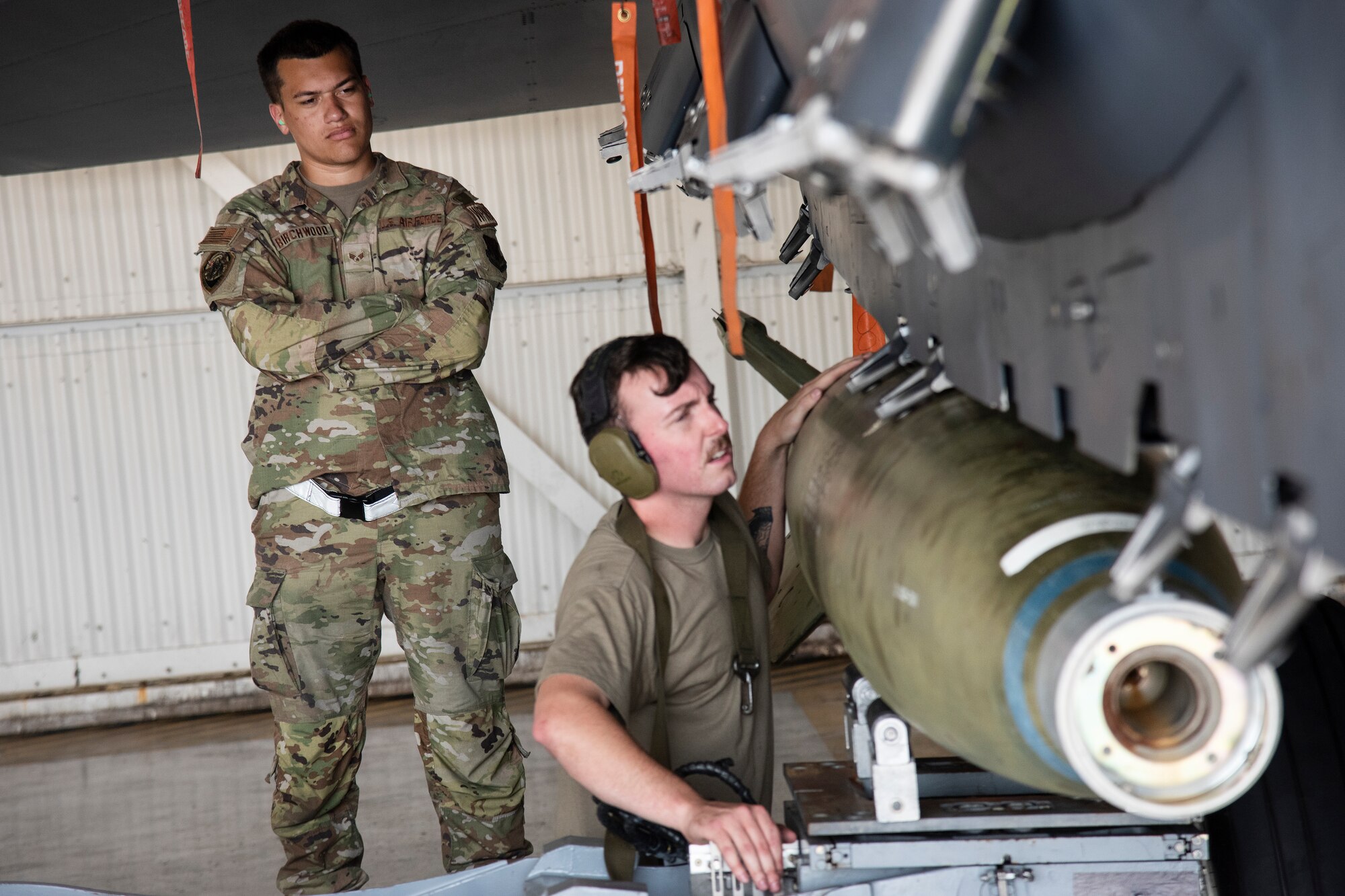 Senior Airman Canaan Birchwood, left, 4th Maintenance Group loading standardization crew member, evaluates Staff Sgt. Michael Fraser, 336th Fighter Generation Squadron, during a weapons standardization load evaluation.