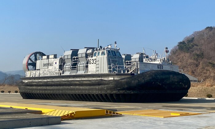 The Landing Ship Fast II (LSF-II) craft 633 is shown after inflating the skirting. This December 2022 operation tested the Command, Control, Communication, Computers, and Navigation (C4N) system for operating the engine and running the lift fans used to inflate the bags in the skirting, and the propellers and air ducts used to maneuver the craft on the tarmac. This is the first time the C4N operated as a system and actively controlled functions aboard the vessel. (courtesy photo provided by Hanjin Shipbuilding and Construction with permission from the Republic of Korea Defense Acquisition Program Administration)