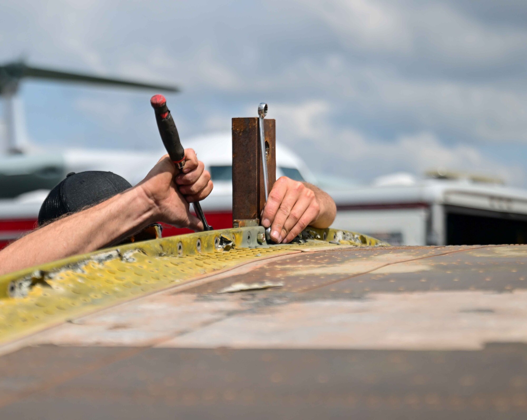 Jesse Bendt, Worldwide Aircraft recovery lead, loosens a bolt on a C-46 Commando at the Air Mobility Command Museum on Dover Air Force Base, Delaware, June 5, 2023.  The C-46 is currently undergoing the restoration process at the AMC Museum, which is expected to take up to two years. (U.S. Air Force photo by Staff Sgt. Faith Barron