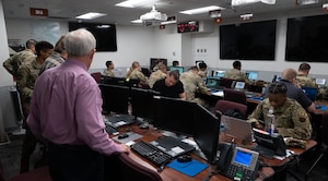 Airmen partake in a hurricane crisis exercise at the Emergency Operations Center.