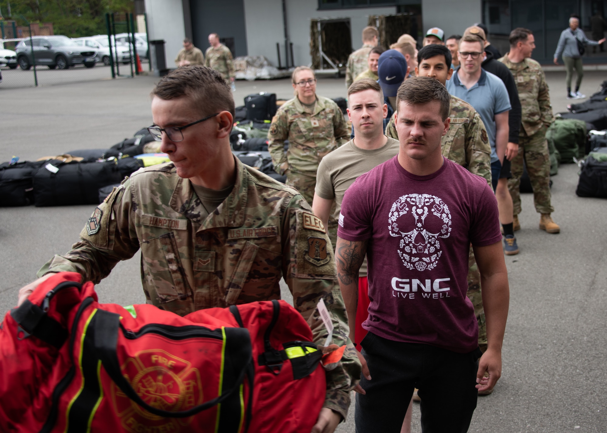 406th Air Expeditionary Wing deployers unload luggage from a trailer after arriving on station from Norfolk, Virginia at Ramstein Air Base, Germany, May 18, 2023.