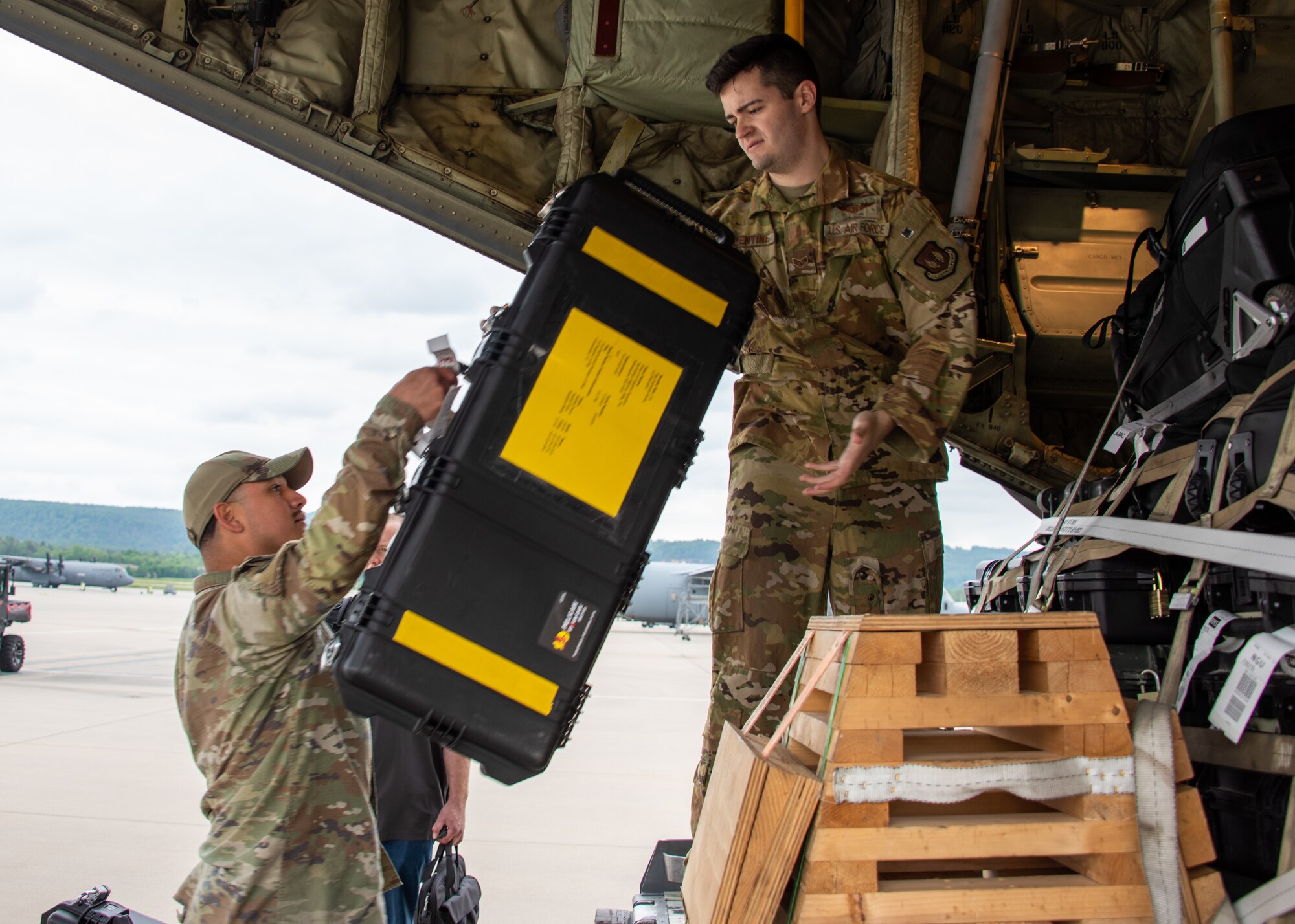 U.S. Air Force Airmen load their luggage onto a C-130J Super Hercules before boarding the aircraft at Ramstein Air Base, Germany, May 23, 2023.