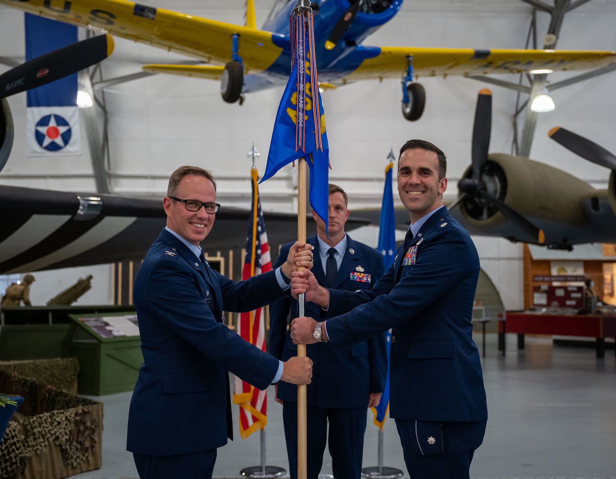 Col. Kenneth Weiner, left, 436th Operations Group commander, passes the guidon to Lt. Col. John Gerlach, incoming 436th Operations Support Squadron commander, during a change of command ceremony at Dover Air Force Base, Delaware, June 14, 2023. The ceremony saw Lt. Col. Steven Hawkins relinquish command to Gerlach. The 436th OSS provides dependable air traffic control, airfield management, weather, intelligence, life support, tactics, mission planning and aircrew training services to support Team Dover’s airlift mission. (U.S. Air Force photo by Airman 1st Class Amanda Jett)
