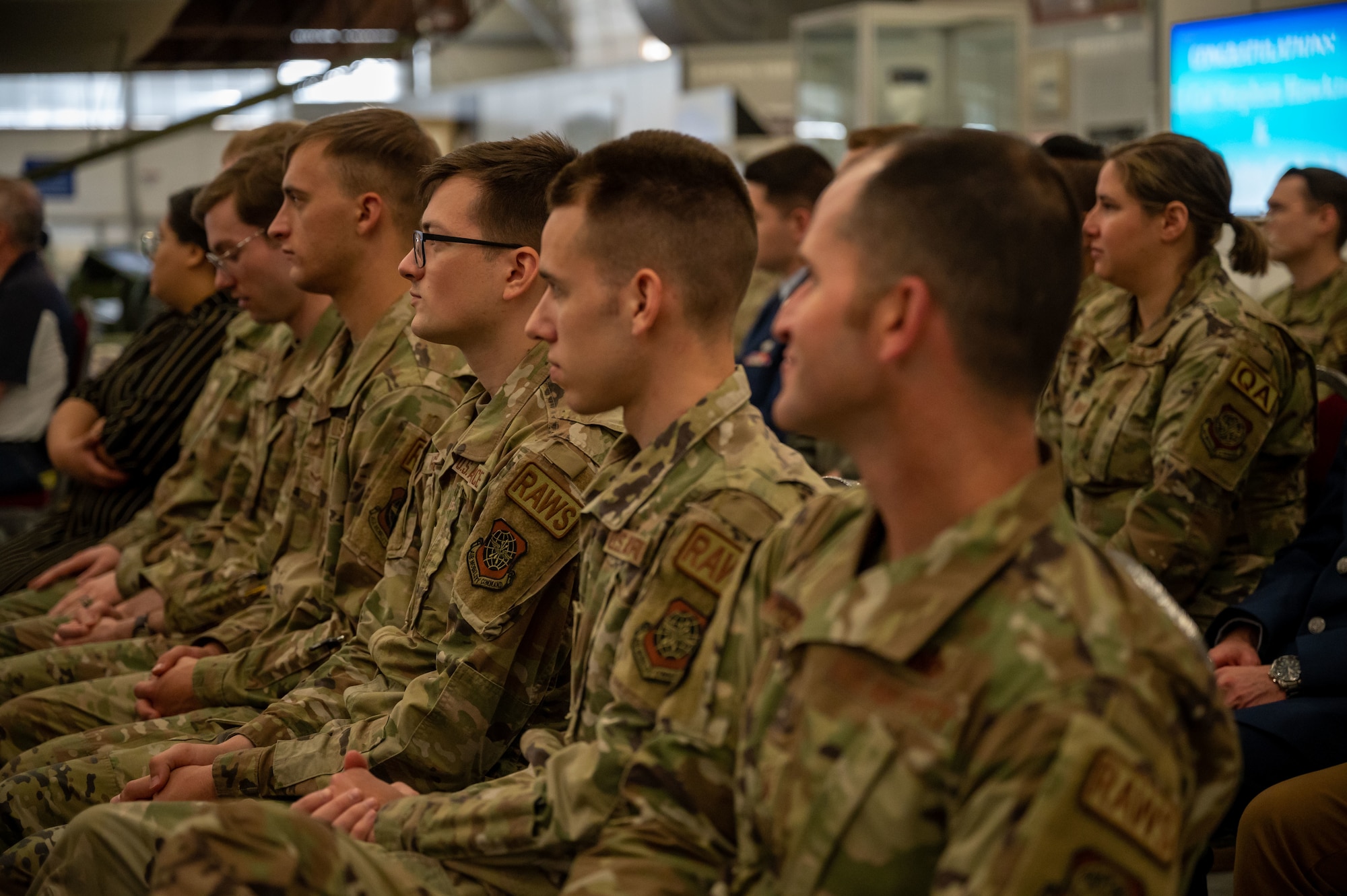 Airmen from the 436th Operations Support Squadron listen to Lt. Col. John Gerlach, incoming 436th O SS commander, present a speech during a change of command ceremony at Dover Air Force Base, Delaware, June 14, 2023. The ceremony saw Lt. Col. Steven Hawkins relinquish command to Gerlach. The 436th OSS provides dependable air traffic control, airfield management, weather, intelligence, life support, tactics, mission planning and aircrew training services to support Team Dover’s airlift mission. (U.S. Air Force photo by Airman 1st Class Amanda Jett)