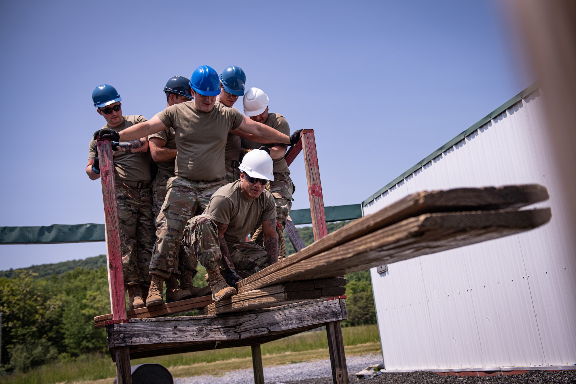 Airmen from the 271st Combat Communications Squadron participate in the leadership reaction course at Fort Indiantown Gap, Pennsylvania, May 21, 2023.