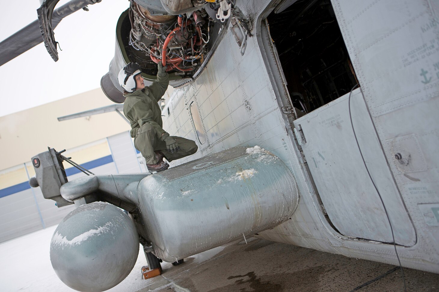 U.S. Marine 1stLt. Whitley Noel, a pilot with Marine Heavy Helicopter Squadron 464 conducts a pre-flight inspection on a CH-53E Super Stallion helicopter before a flight in Brunswick, ME., January 23, 2018. Marines with HMH-464 are participating in a training exercise in Brunswick, ME., and are conducting mountainous and maritime operations to get accustomed to training and operating in cold weather environments.