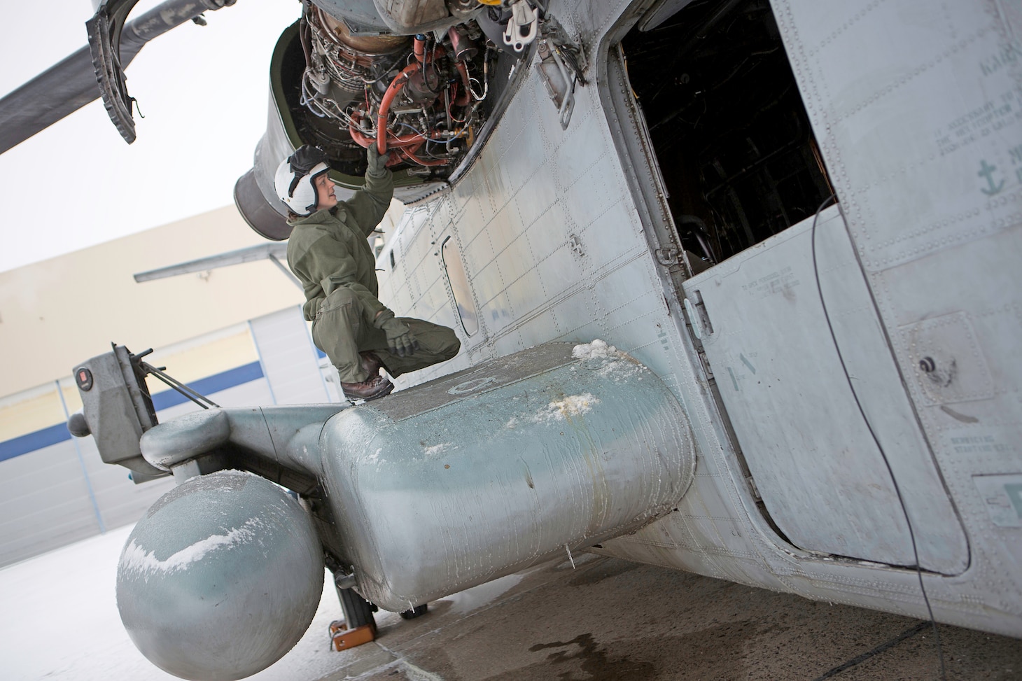 U.S. Marine 1stLt. Whitley Noel, a pilot with Marine Heavy Helicopter Squadron 464 conducts a pre-flight inspection on a CH-53E Super Stallion helicopter before a flight in Brunswick, ME., January 23, 2018. Marines with HMH-464 are participating in a training exercise in Brunswick, ME., and are conducting mountainous and maritime operations to get accustomed to training and operating in cold weather environments.