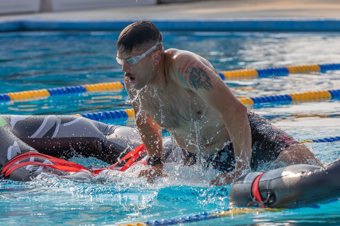 Army Staff Sgt. James Lavoie completes a swim obstacle