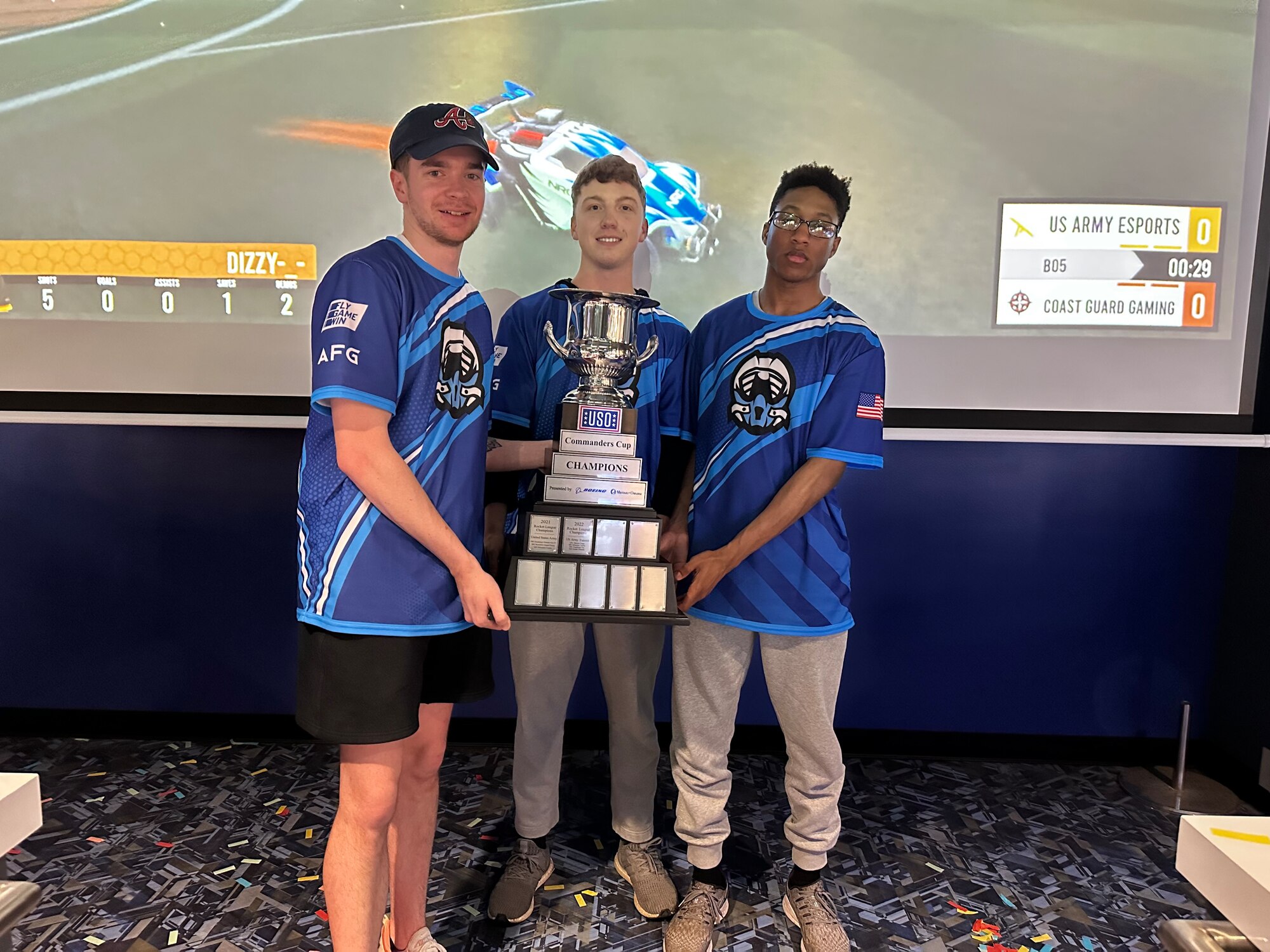 A 90 MW Airman holds a trophy at the e-Sports Commanders Cup.