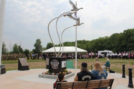 With 45 New York Army National Guard aviation Soldiers in formation, officials of the town of Mendon, New York, unveiled a memorial to three of their fellow members June 11, 2023. The Army Guard aviators died in a helicopter crash in the town on Jan. 20, 2021.