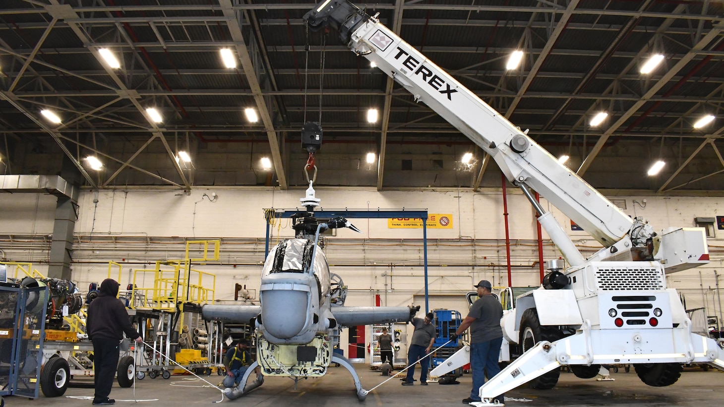 Artisans on the H-1 production line prepare an AH-1Z helicopter for movement from the Fleet Readiness Center East (FRCE) detachment at Marine Corps Air Station (MCAS) New River to the FRCE depot at MCAS Cherry Point. The move marked the first use of FRCE’s new double drop trailer – commonly called a lowboy – which stands to help FRCE save money and reduce turnaround time by simplifying movement of aircraft and other heavy equipment between the depot’s sites.