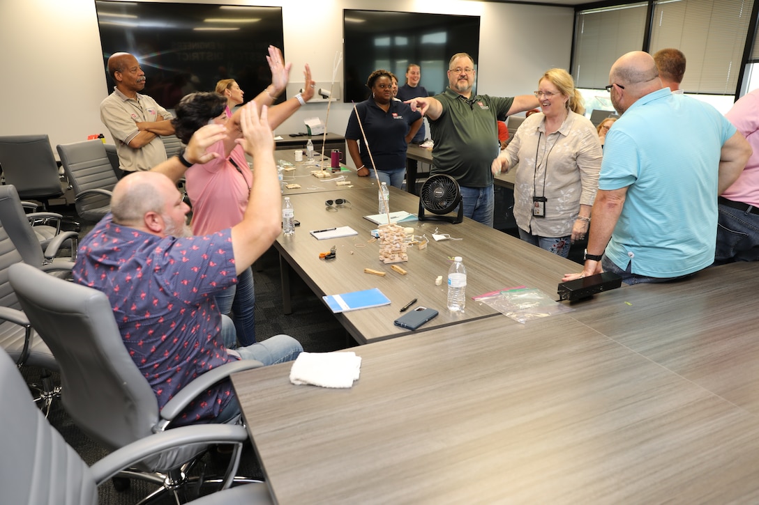 The teams had 20 minutes to complete their tower with popsicle sticks, pipe cleaners and scotch tape. Jeremy Babb, Chief Supplemental Program Branch, in green, led the exercise and provided simulated hurricane category 3 winds to test each tower. The team with the tallest tower which withstood the storm were the winners.