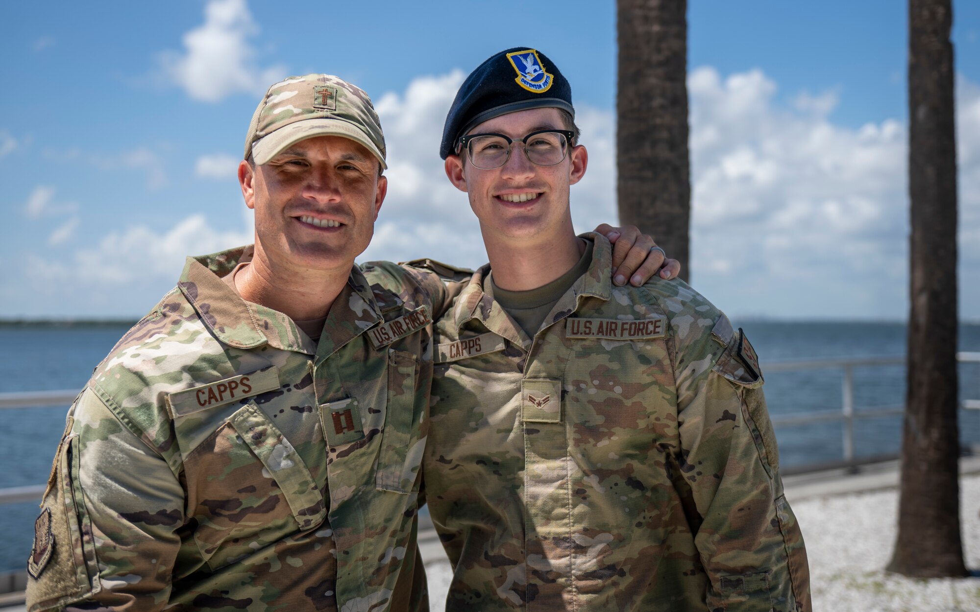 U.S. Air Force Capt. Kory Capps, a chaplain assigned to the 6th Air Refueling Wing, and his son, Airman 1st Class Karter Capps, a defender assigned to the 66th Security Forces Squadron at Hanscom Air Force Base, pose for a photo at MacDill AFB, Florida, June 14, 2023. This father and son duo have an unwavering bond and dedication to the military exemplifying the essence of service, sacrifice, and love. (U.S. Air Force photo by Senior Airman Lauren Cobin)