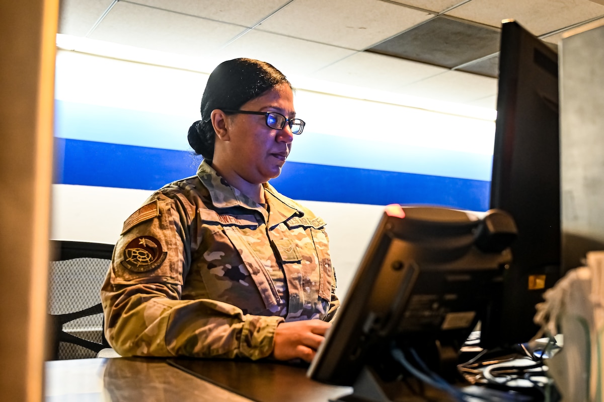 Airman 1st Class Marian Tawfik, 305th Aerial Port Squadron air transportation specialist, in-processes travelers at the 305th APS Passenger Terminal April 19, 2023, at Joint Base McGuire-Dix-Lakehurst, N.J. Tawfik, an immigrant from Minya, Egypt, won a diversity Visa through the U.S. Embassy lottery and eventually attained her citizenship in the United States. (U.S. Air Force photo by Senior Airman Matt Porter)