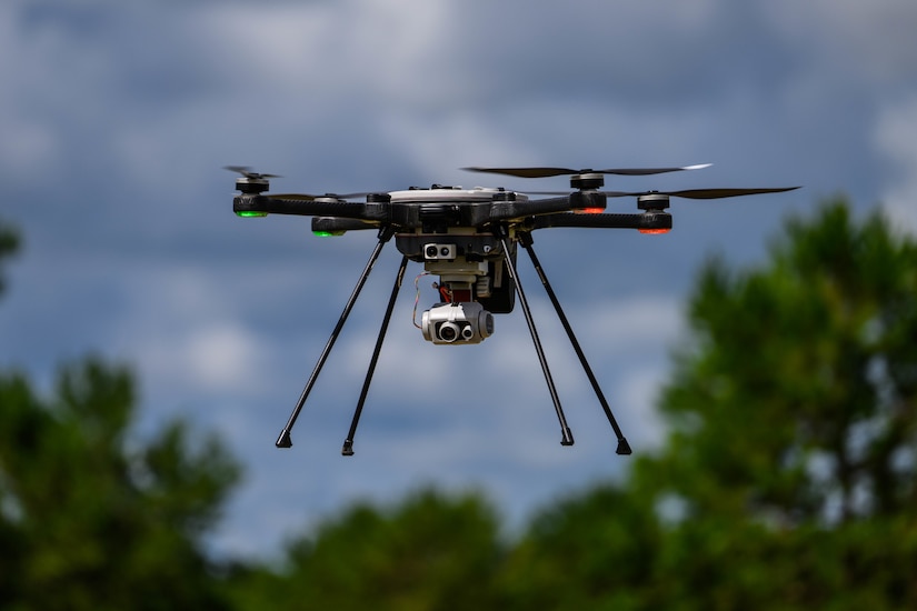 A small drone is photographed while hovering.