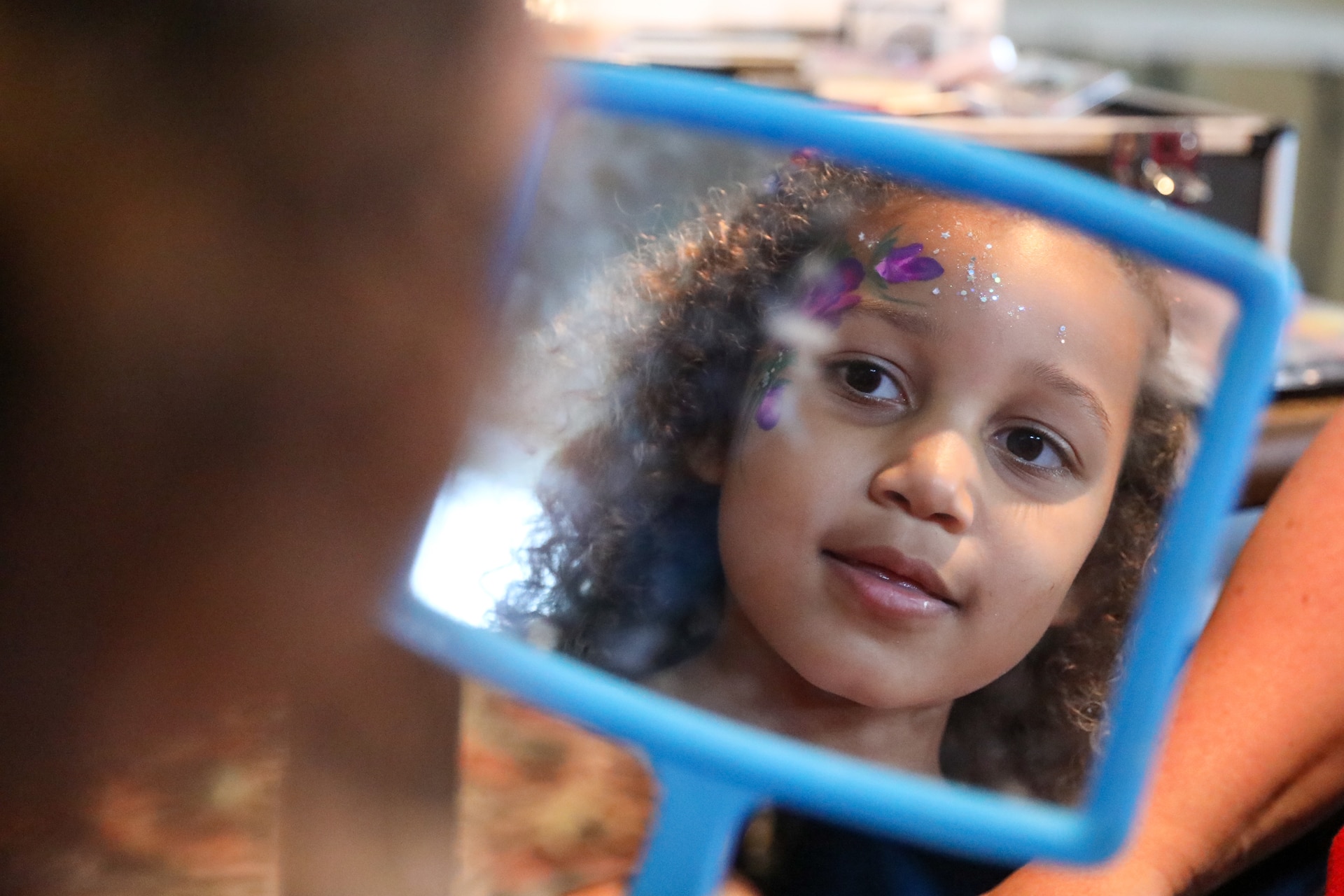 Aubrey Payne, the niece of fallen Kentucky Guardsmen Sgt. Darrin Potter, admires her face painting during the Survivors Outreach Services Riverboat cruise along the Ohio River near Cincinnati, Ohio, June 23, 2023. The day is designed to recognize the surviving family members of military service members who have given their lives in defense of our nation. (U.S. Army National Guard photos by Sgt. Matt Damon)