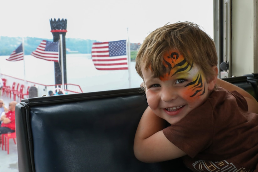 Declan Trefz, the nephew of fallen Soldier Pvt. Dylan Trefz, smiles in the wheelhouse of the Belle of Cincinnati during the Survivors Outreach Services Riverboat cruise along the Ohio River near Cincinnati, Ohio, June 23, 2023. The day is designed to recognize the surviving family members of military service members who have given their lives in defense of our nation. (U.S. Army National Guard photos by Sgt. Matt Damon)