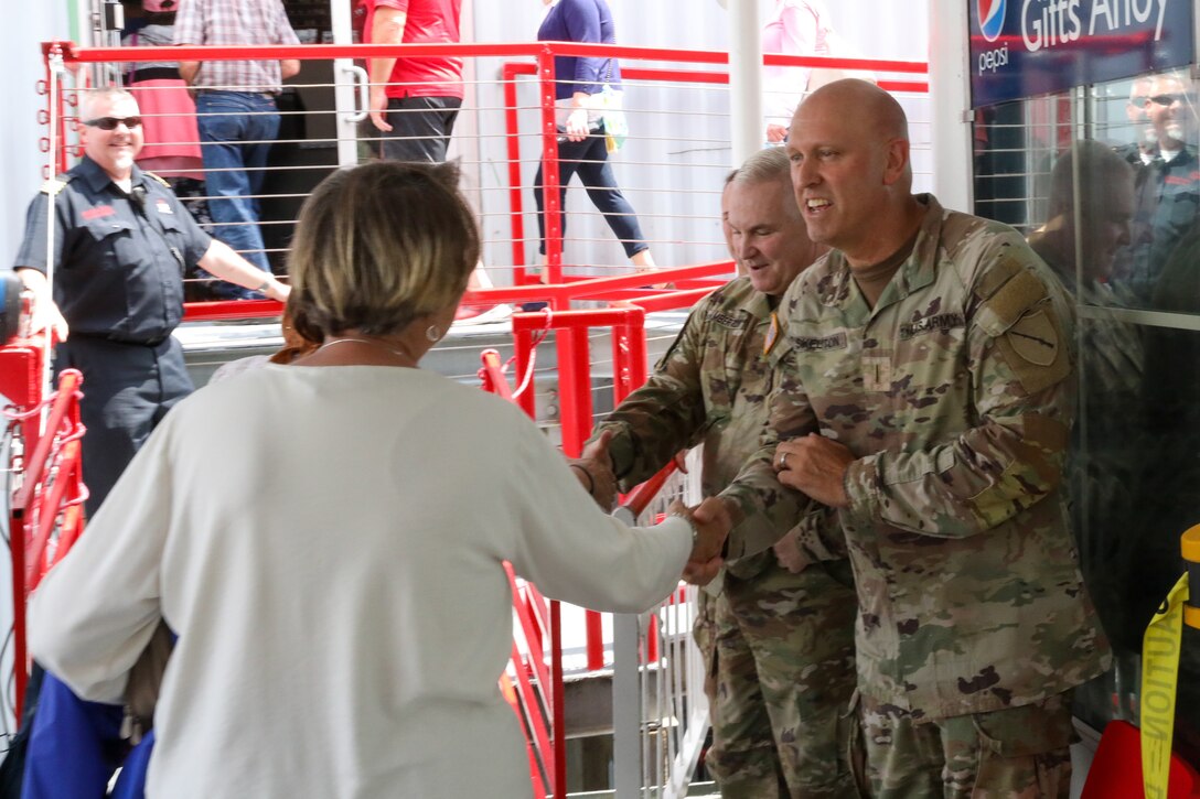 Kentucky National Guard leaders Maj. Gen. Haldane Lamberton (center), the adjutant general of the Kentucky National Guard, and Chief Warrant Officer 5 Rickey Skelton (right), state command chief warrant officer of the Kentucky National Guard, greet guests as they disembark the riverboat during the Survivors Outreach Services Riverboat cruise along the Ohio River near Cincinnati, Ohio, June 23, 2023. The day is designed to recognize the surviving family members of military service members who have given their lives in defense of our nation. (U.S. Army National Guard photos by Sgt. Matt Damon)
