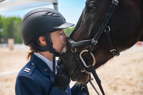 U.S. Air Force Capt. Magin Day, Operational Medicine Readiness Squadron flight commander, kisses Rumor, her horse, after completing the first day events of the two-day 2023 Queeny Park Equestrian Events Horse Trials at the National Equestrian Center, St. Louis, Missouri, June 10, 2023. The first day of events consisted of dressage and stadium jumping. (U.S. Air Force photo by Airman 1st Class De’Quan Simmons)