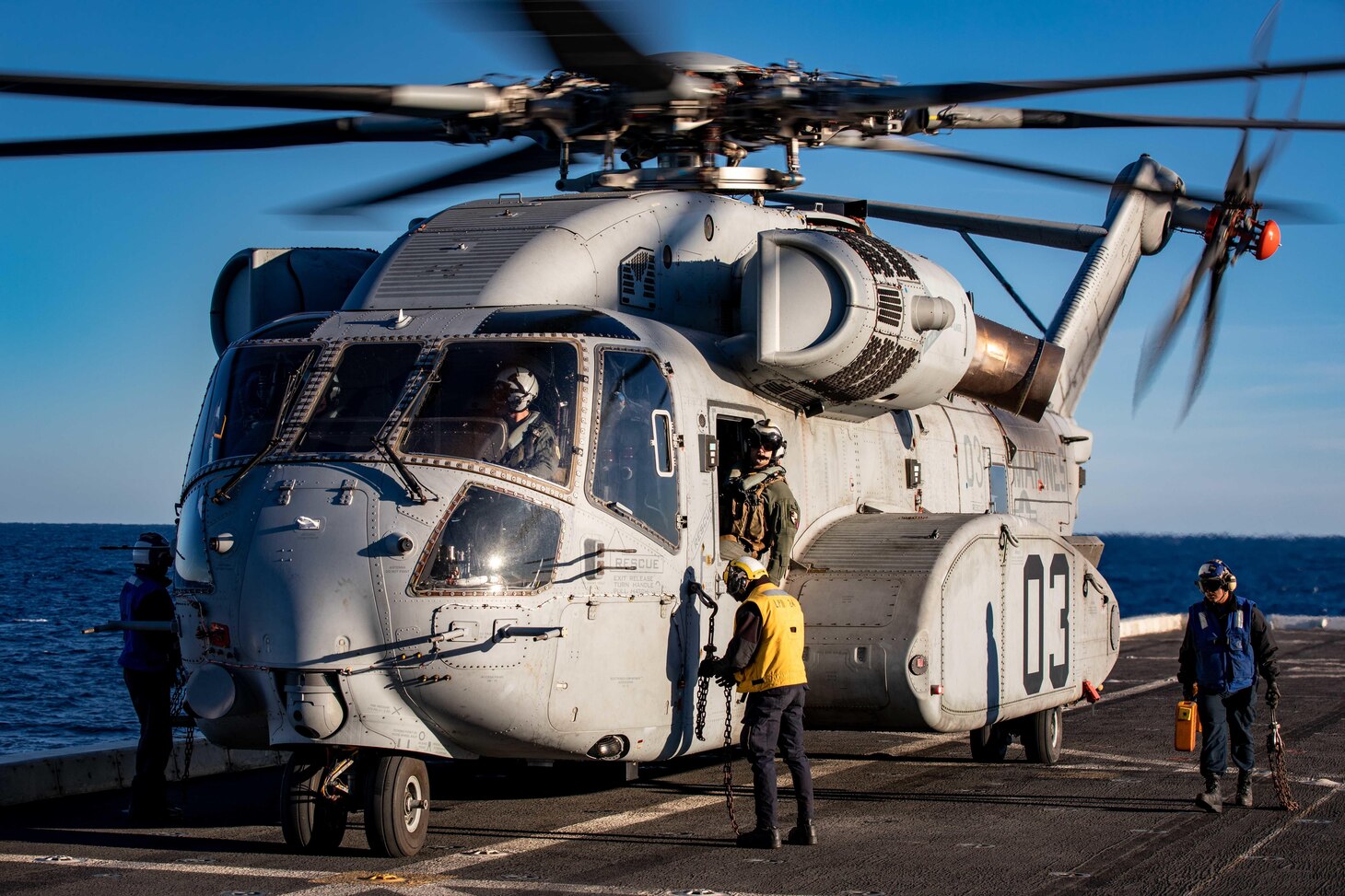 Sailors assigned to the San Antonio-class amphibious transport dock ship USS Arlington (LPD 24) remove chocks and chains from a CH-53K King Stallion helicopter during flight operations aboard Arlington, Feb. 14. The King Stallion is a heavy-lift cargo helicopter that underwent its second set of sea trials as the next evolution of the CH-53 series helicopters that have been in service since 1966.