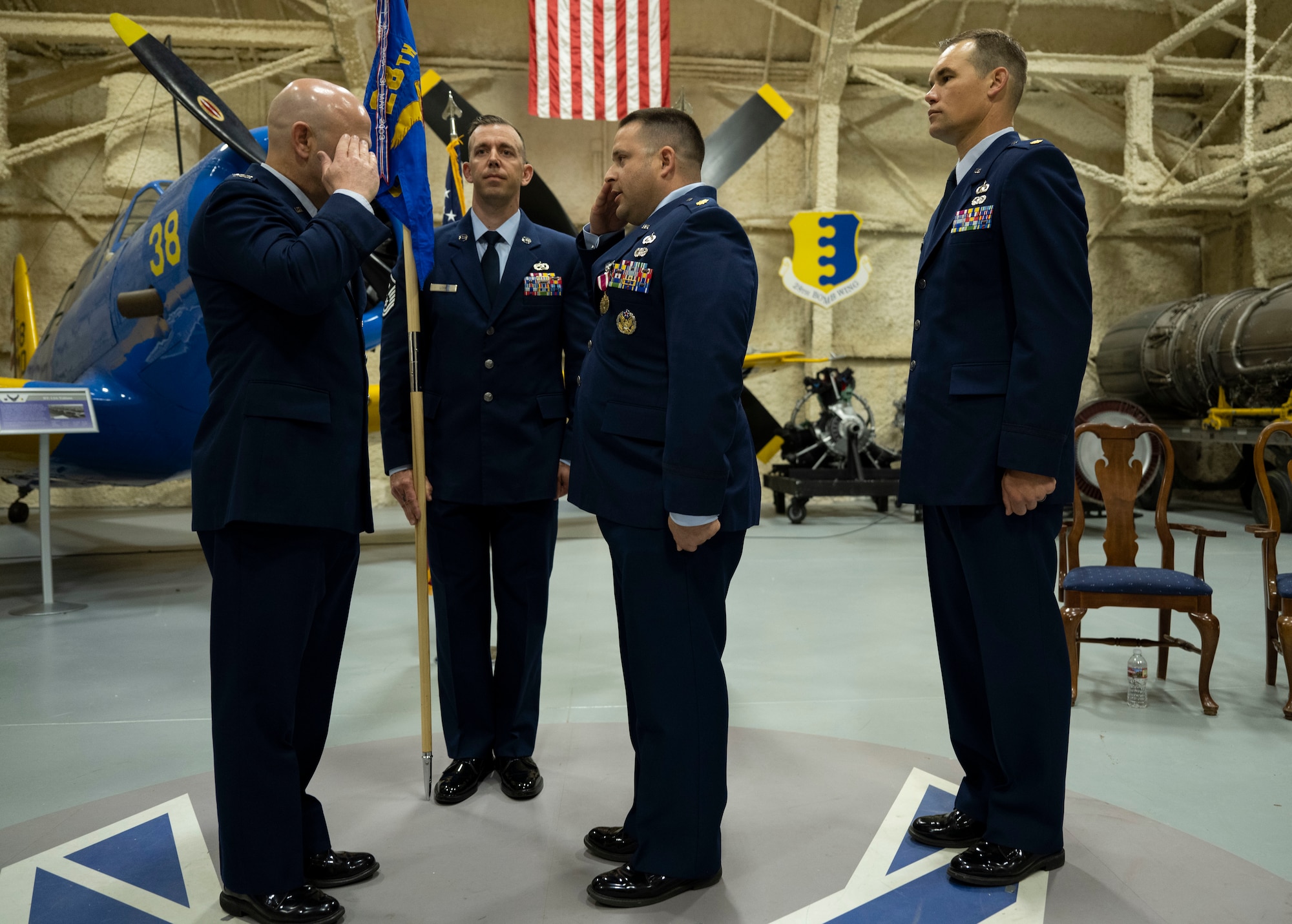 U.S. Air Force Col Joseph Sheffield (left), 28th Bomb Wing commander, returns a salute from Maj Nicholas DeFranco, outgoing 28th Comptroller Squadron commander at Ellsworth Air Force Base, South Dakota, June 15, 2023.