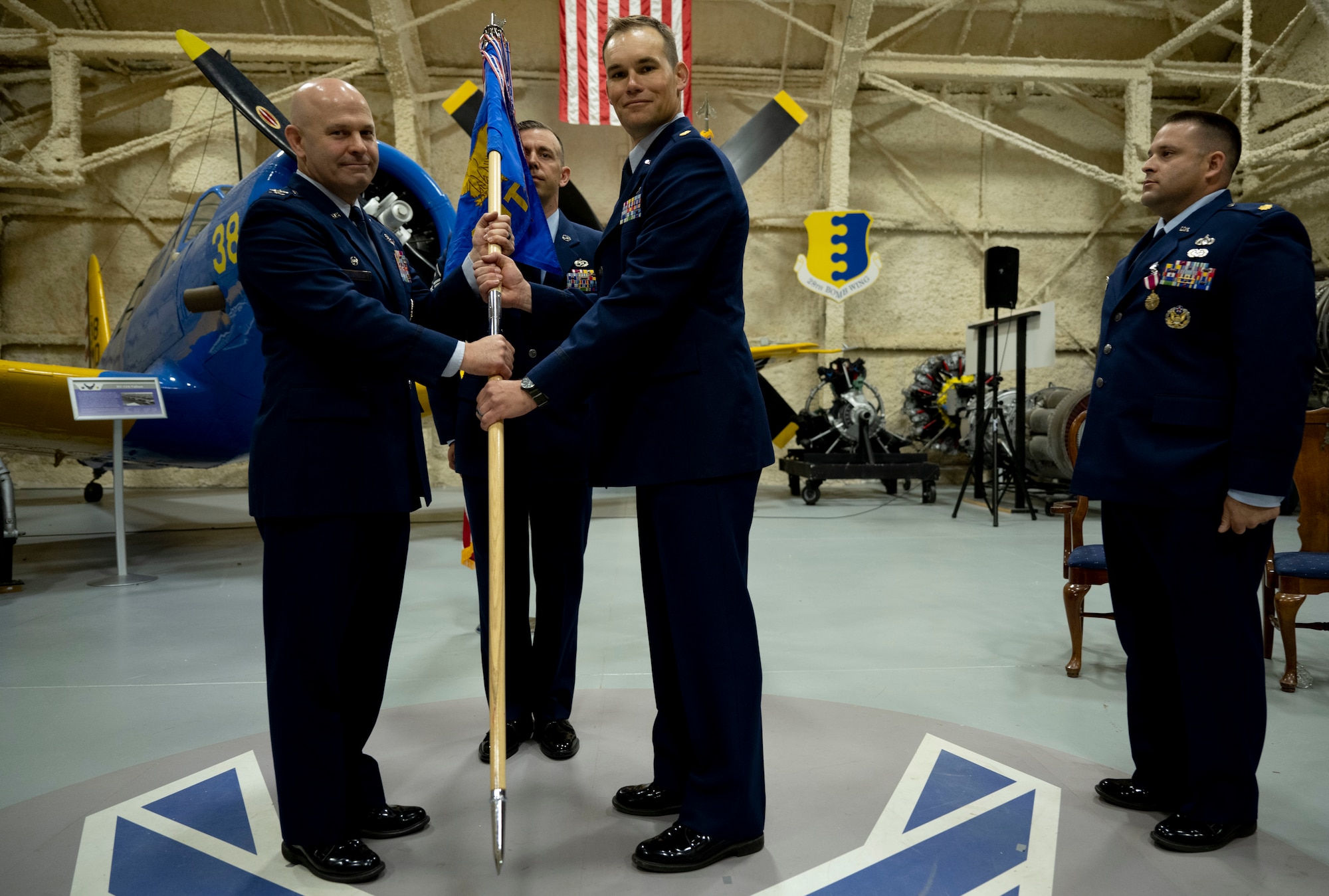 U.S. Air Force Col Joseph Sheffield (left), 28th Bomb Wing commander, presents the 28th Compstroller Squadron’s Guidon to Maj John “Jack” Rosson, incoming 28th CPTS commander, at Ellsworth Air Force Base, South Dakota, June 15, 2023.