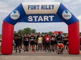 1st Infantry Division Soldiers and Family members prepare to run the Victory 10K event at Fort Riley Outdoor Recreation, Fort Riley, Kansas, June 13, 2023. The Victory 10K was one of many events for Victory Week, which is held annually to boost morale and build team cohesion. (U.S. Army photo by Spc. Daniela Lechuga)