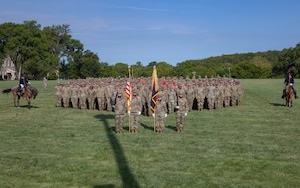 Soldiers from the 1st Infantry Division lined up in formation to recreate a historical photo of the unit insignia on the Cavalry Parade Field on Fort Riley, Kansas, June 14, 2023. After the historical photo the divisions Victory Cup winner was announced. (U.S. Army photo by Pfc. Koltyn O’Marah)