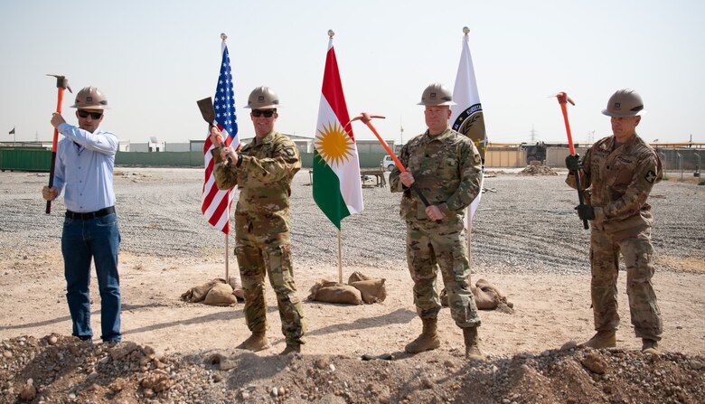 The U.S. Army Corps of Engineers team at Erbil Air Base, Iraq, along with senior base leadership and stakeholders, hold a groundbreaking ceremony to mark the start of construction for the Life Support Area (LSA) Roberts Dining Facility, Erbil Air Base, Iraq, August 2, 2022. When completed in March 2023, the DFAC will serve more than 1800 meals a day in a semi-permanent structure, replacing the current field condition Alaska tent structures. When completed in March 2023, the DFAC will serve more than 1800 meals a day in a semi-permanent structure, replacing the temporary current field condition Alaska tent structures that have served the joint and coalition forces on base since 2016.
