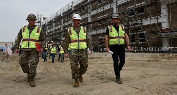 Col. William C. Hannan, Jr., U.S. Army Corps of Engineers Transatlantic Division commander (Center), Col. Richard Childers, Transatlantic Expeditionary District commander (left), and Ahmed A. Madhkoor, P.E., PMP, Expeditionary District mechanical engineer and project engineer (right), walk a project site at Camp Arifjan, Kuwait, Jan. 26.