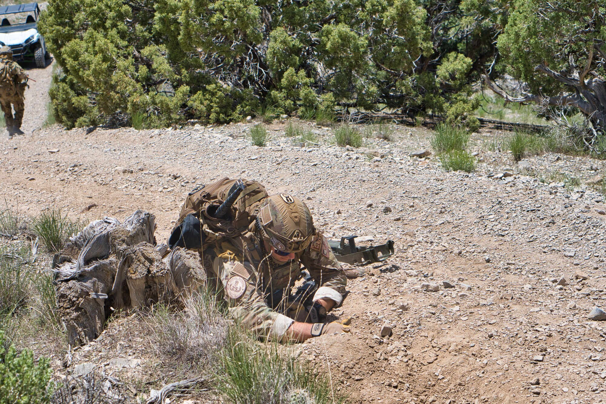 An airman works on the ground