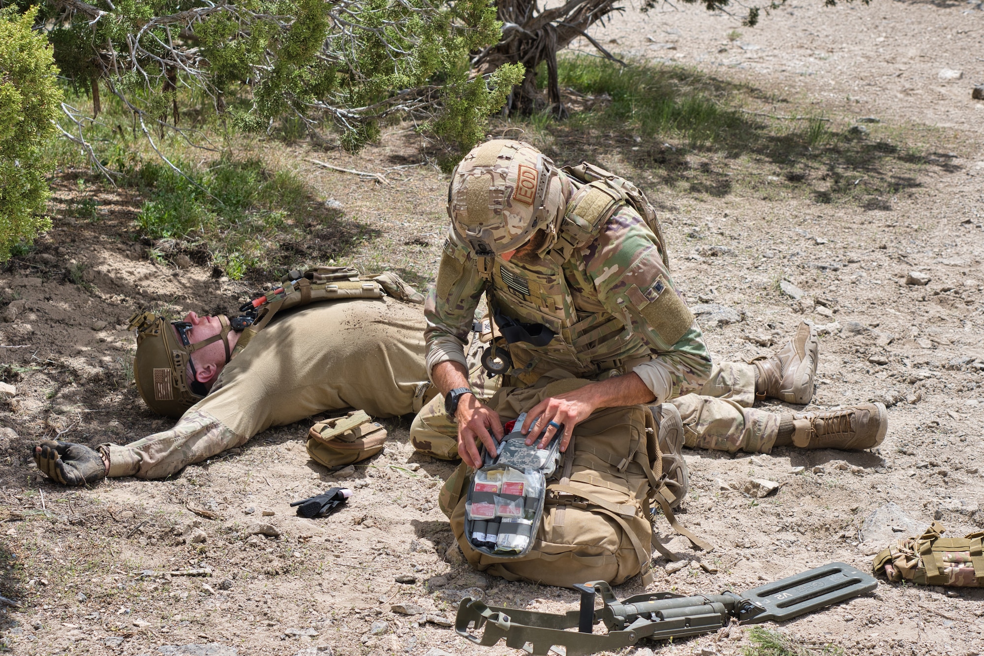 One Airman renders first aid to another