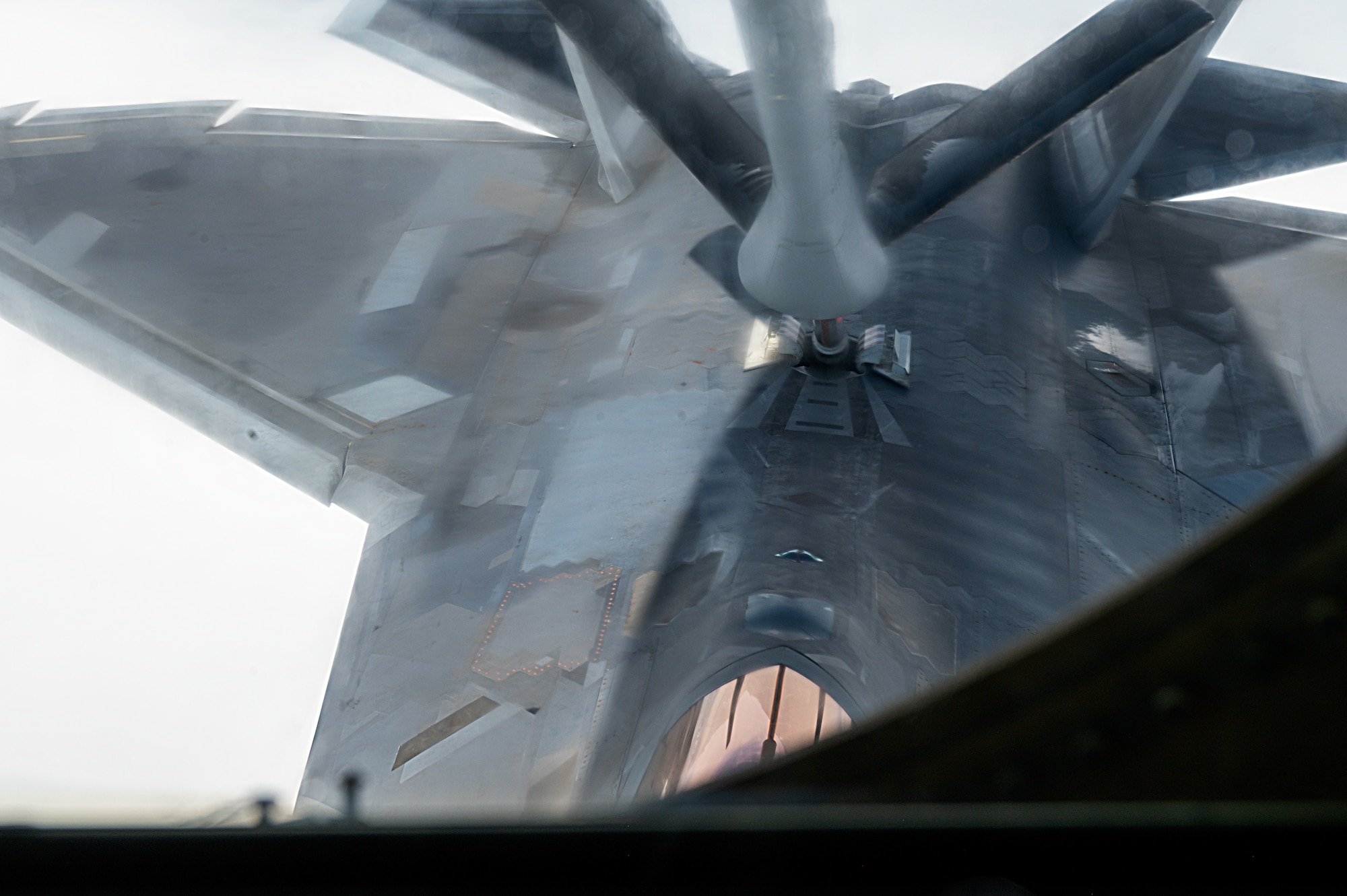A U.S. Air Force F-22 Raptor receives fuel from a KC-135 Stratotanker assigned to Fairchild Air Force Base, over Alaska, during a Phase 3 Lead Wing exercise, June 6th, 2023. The 92nd Air Refueling Wing deployed personnel and KC-135 Stratotankers, to execute a Phase 3 Lead Wing exercise in preparation to be lead tanker wing at Air Mobility Command’s capstone exercise, Mobility Guardian 2023.