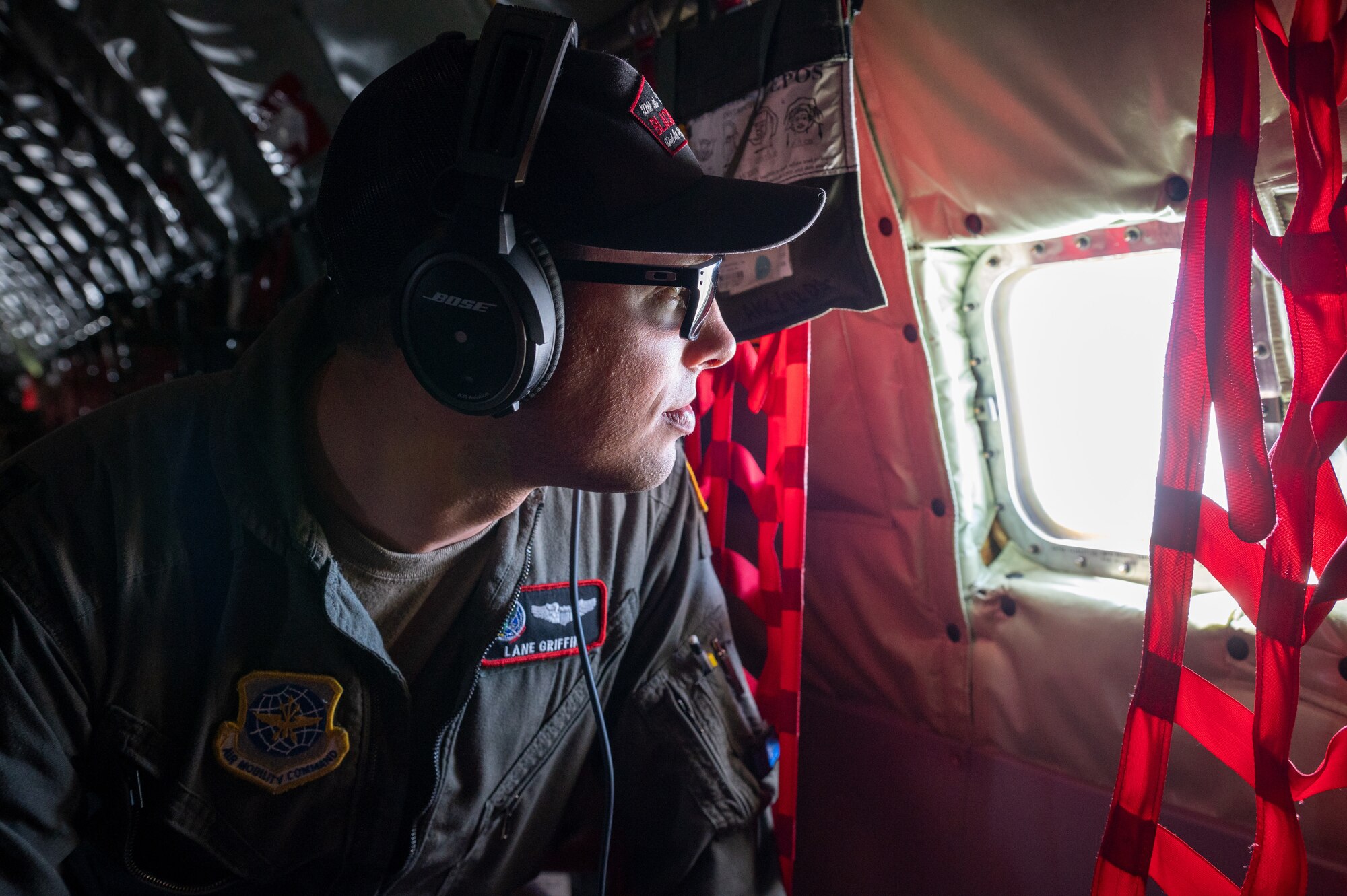 U.S. Air Force Capt Lane Griffin, 92nd Air Refueling Squadron pilot, looks out the window of a KC-135 Stratotanker during a Phase 3 Lead Wing exercise, June 6th, 2023. The exercise emphasized aircrew endurance while crew resting on the aircraft, wearing devices that track real time fatigue/stress on the aircrew, dynamic air refueling concepts, testing of a variety of the KC-135 mission sets, and included an advanced 72-hour endurance event.