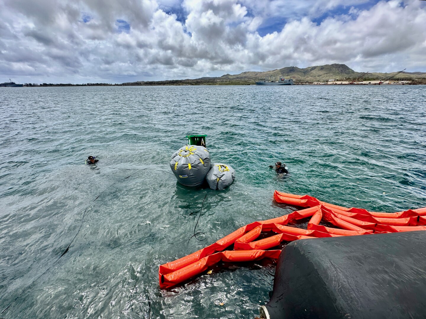 U.S. Coast Guard Station Regional Dive Locker Pacific members refloat a sunken buoy with lift bags on June 6, 2023, as a joint team works aids at Victor Pier in inner Apra Harbor affected by Typhoon Mawar.