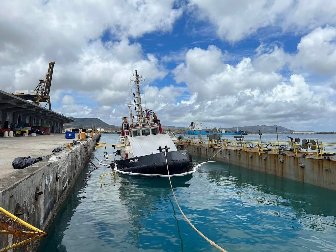 U.S. Coast Guard Incident Management Assist Team members observe efforts to refloat the tug Polaris on June 11, 2023, in the Port of Guam.