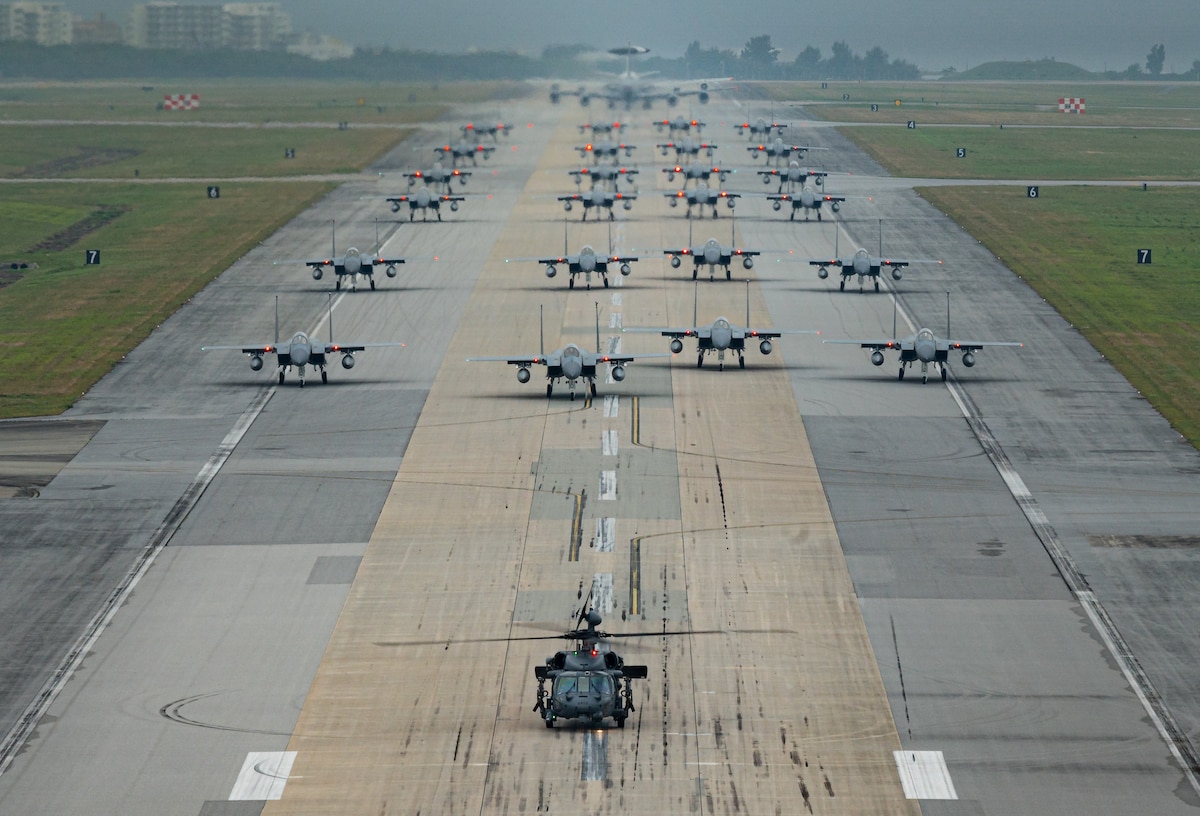 A formation of F-15C/D Eagles assigned to the 44th and 67th Fighter Squadrons, a KC-135 Stratotanker assigned to the 909th Air Refueling Squadron, an E-3 Sentry assigned to the 961st Airborne Air Control Squadron, and an HH-60 Pavehawk assigned to the 33rd Rescue Squadron taxi during a routine wing readiness exercise at Kadena Air Base, Japan, March 2, 2022. The large formation movement was part of a routine exercise scenario that tested the 18th Wing’s ability to generate airpower in support of the defense of Japan and other partner nations, ensuring the stability and security of a free and open Indo-Pacific. (U.S. Air Force photo by Senior Airman Stephen Pulter)