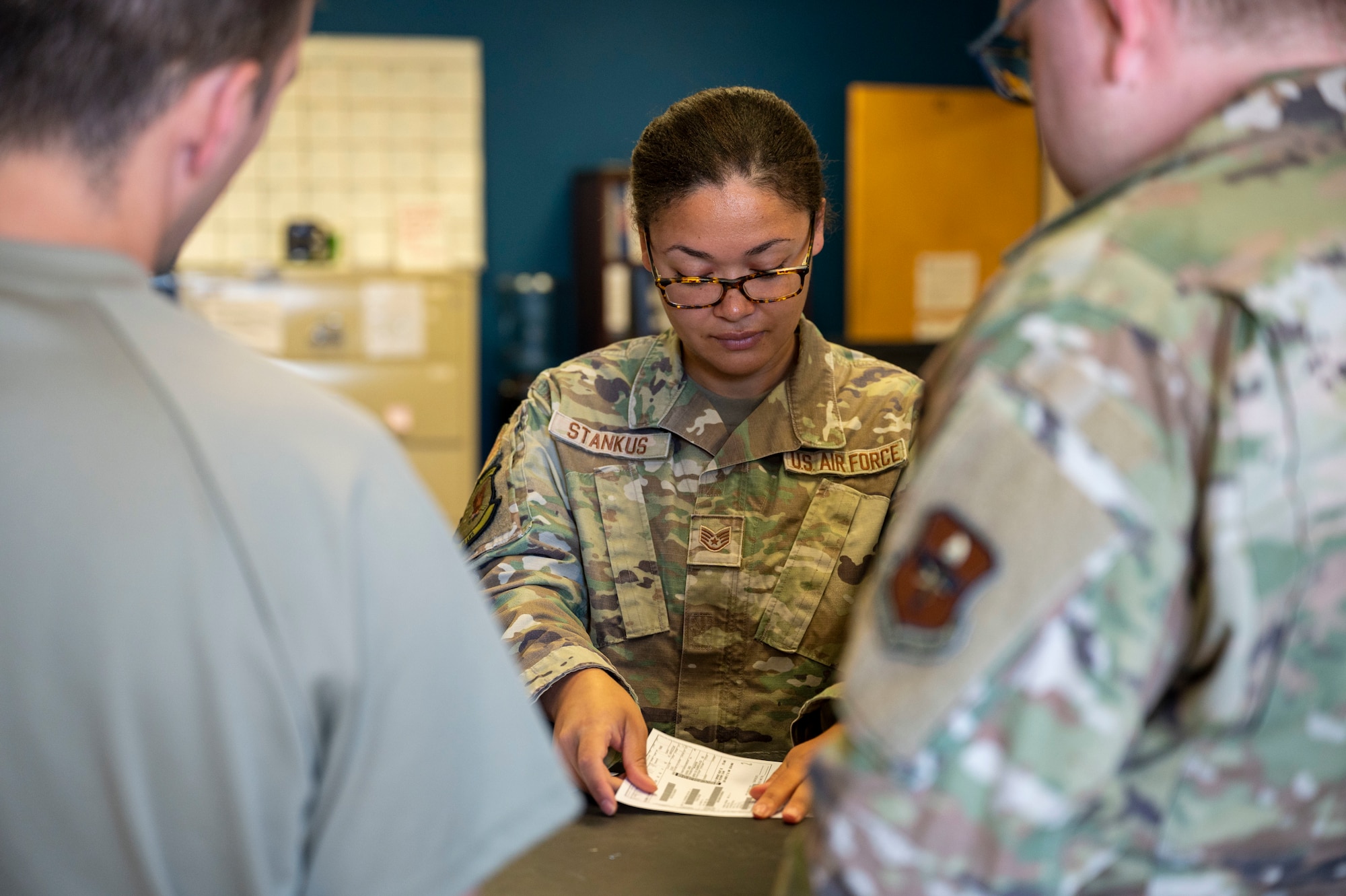 U.S. Air Force Staff Sgt. O'Shea Stankus, 49th Logistics Readiness Squadron aircraft parts store supervisor, helps two customers get a part at Holloman Air Force Base, New Mexico, June 12, 2023.