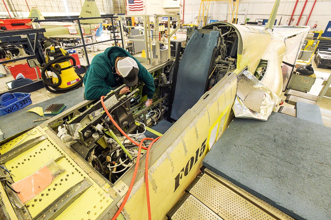 Sheet metal apprentice Evan Durflinger, assigned to Fleet Readiness Center Southeast’s F-5 Production Line, works to replace the upper canopy longeron (UCL) on an F-5N Tiger II. UCLs are the main structural components of the airframe, providing rigidity to the aircraft around the cockpit.
