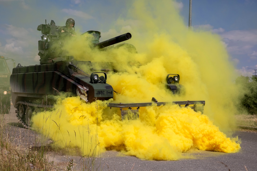 A tank is enveloped in yellow smoke.