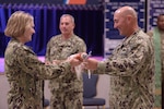 U.S. Coast Guard Commandant Adm. Linda Fagan and Cmdr. James Lovenstein, Port Security Unit (PSU) 305’s commanding officer, roll the unit guidon as Master Chief Petty Officer Thomas Lepage, PSU 305’s command master chief, extends it during the unit’s casing of the colors decommissioning ceremony at Naval Station Guantanamo Bay, Cuba, June 13, 2023. PSU 305, based in Fort Eustis, Va., was the first unit in 2002 to begin the Coast Guard’s mission with Joint Task Force Guantanamo Bay and is the last to complete it. (U.S. Coast Guard photo by Petty Officer 1st Class Valerie Higdon)