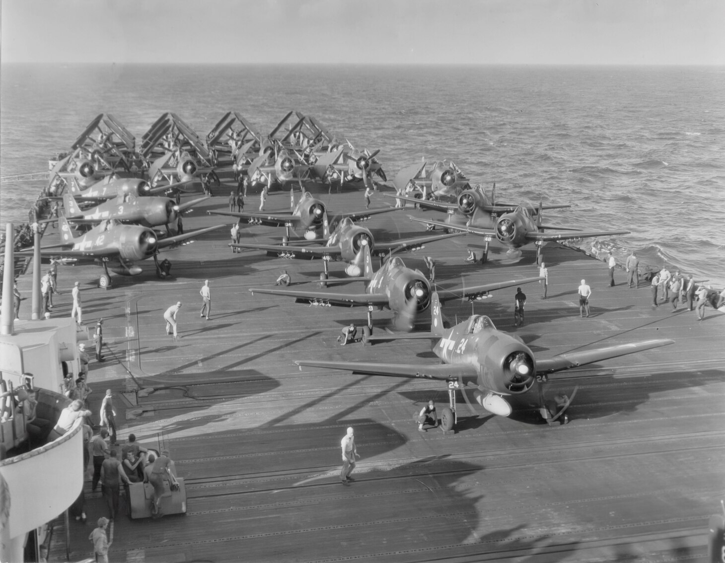 VF-11 Grumman F6F-5 Hellcats getting ready to launch off USS Hornet (CV-12) with VT and VB-11 TBMs and SB2Cs start engines for a raid on Nasnsi Shoto on 10 October 1944. CAG-11.