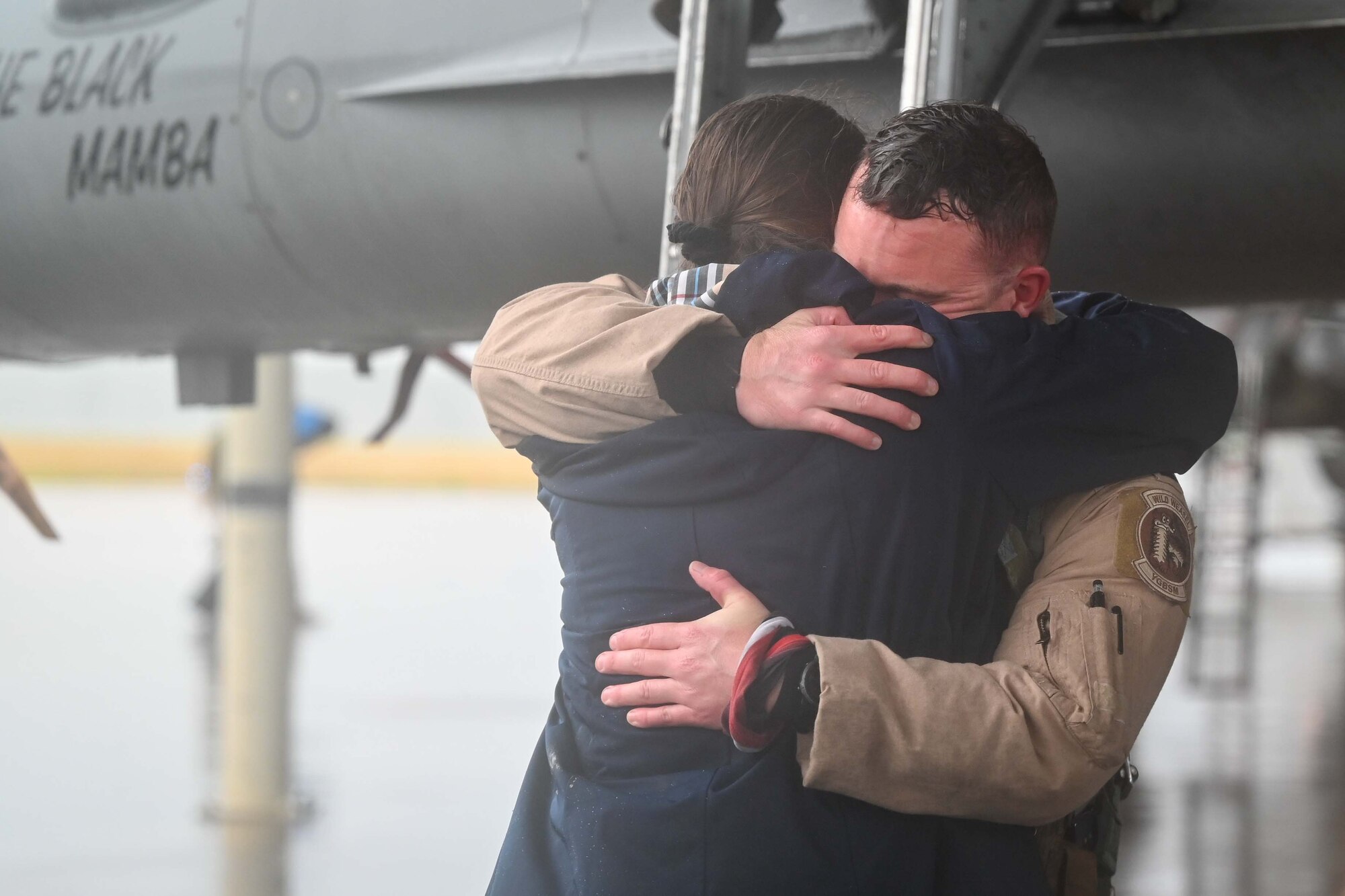 A pilot hugs his loved one after exiting his aircraft.