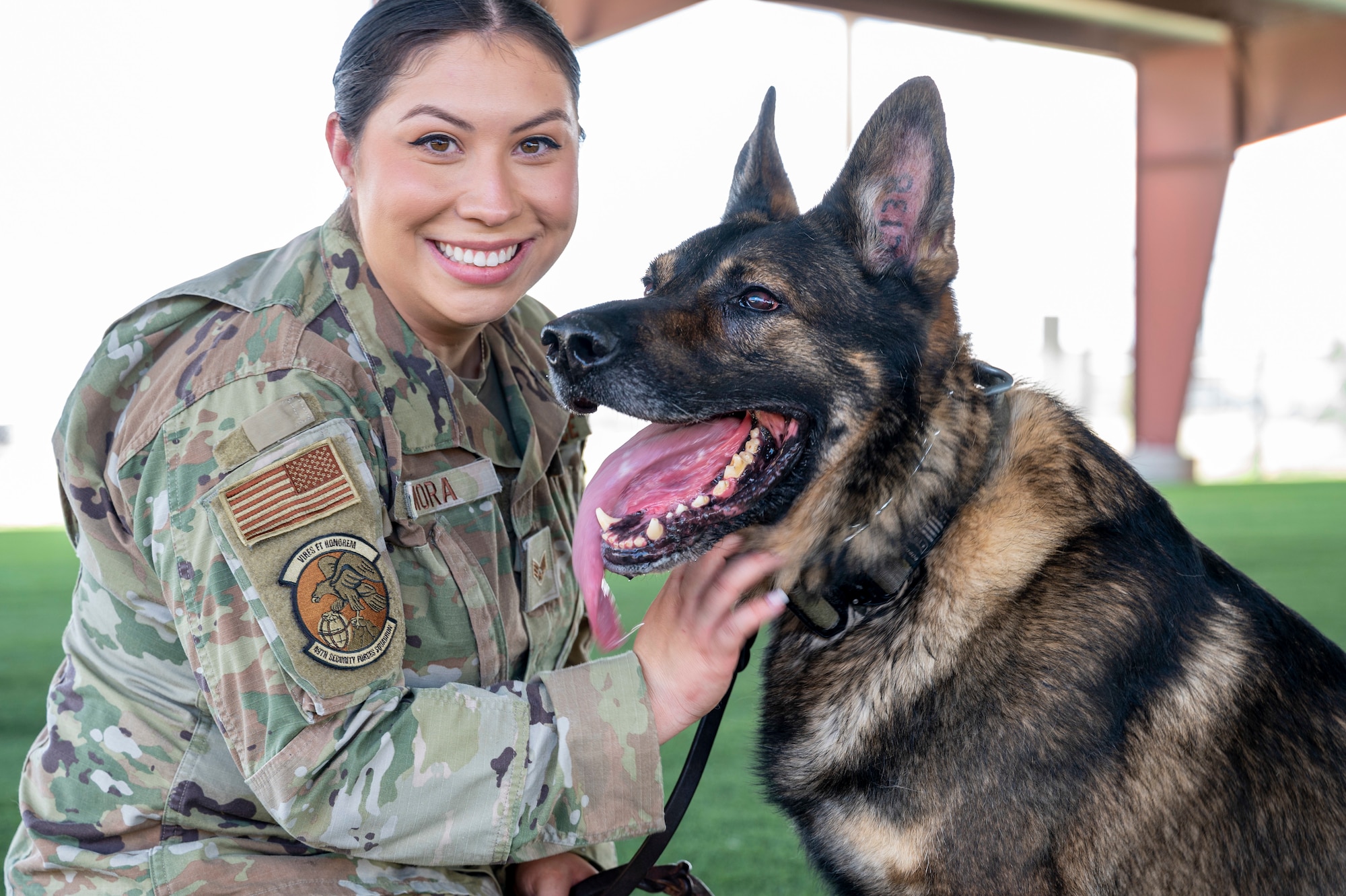 U.S. Air Force Senior Airman Elyse Mora, 49th Security Forces Squadron military working dog handler and her MWD Ilay, pose for a photo at Holloman Air Force Base, New Mexico, May 23, 2023.