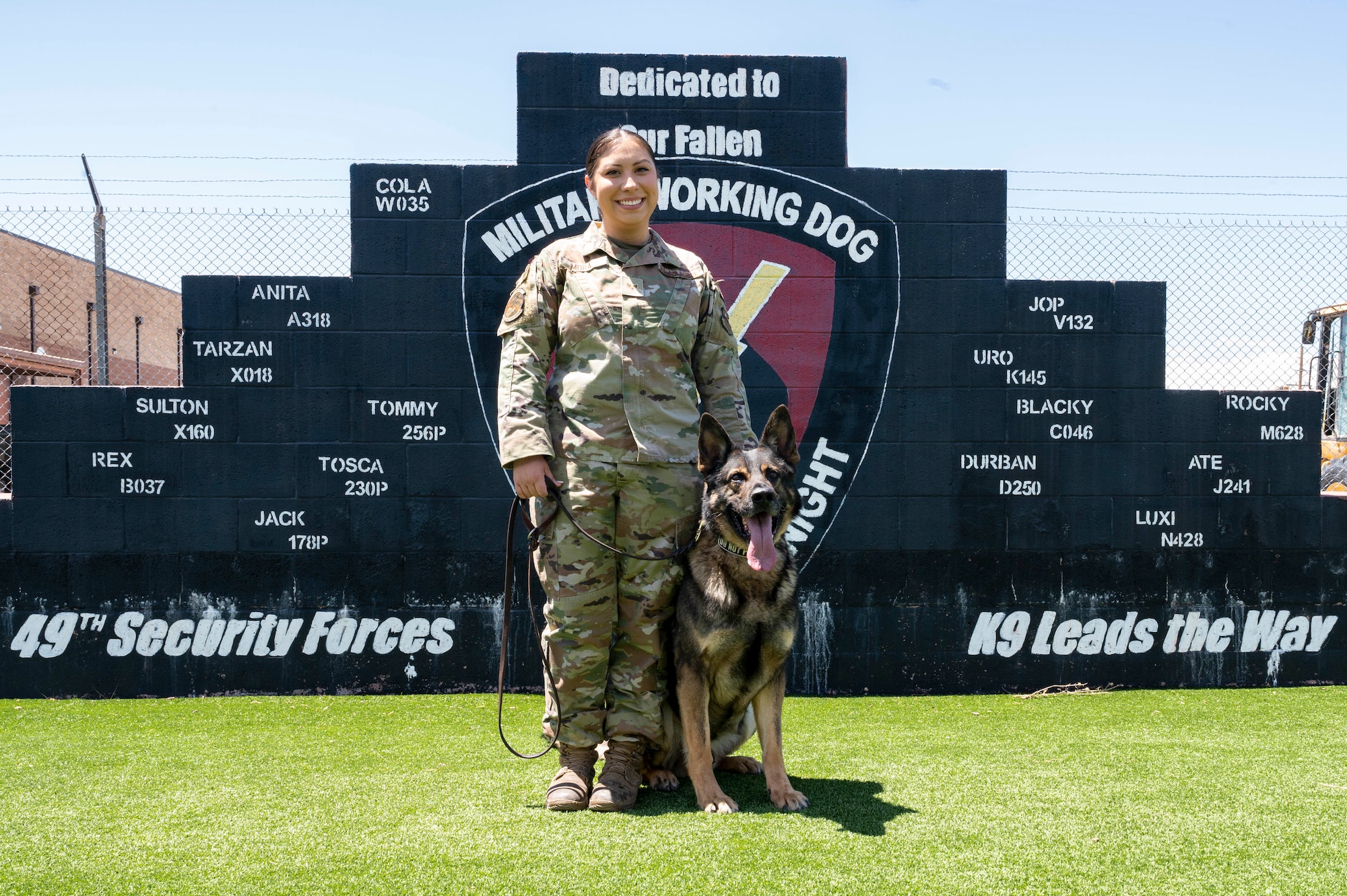 U.S. Air Force Senior Airman Elyse Mora, 49th Security Forces Squadron military working dog handler, and Ilay, a MWD, pose for a photo at Holloman Air Force Base, New Mexico, May 23, 2023.