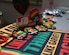 Multiple green red and yellow pins with Juneteenth logos sit on a table.