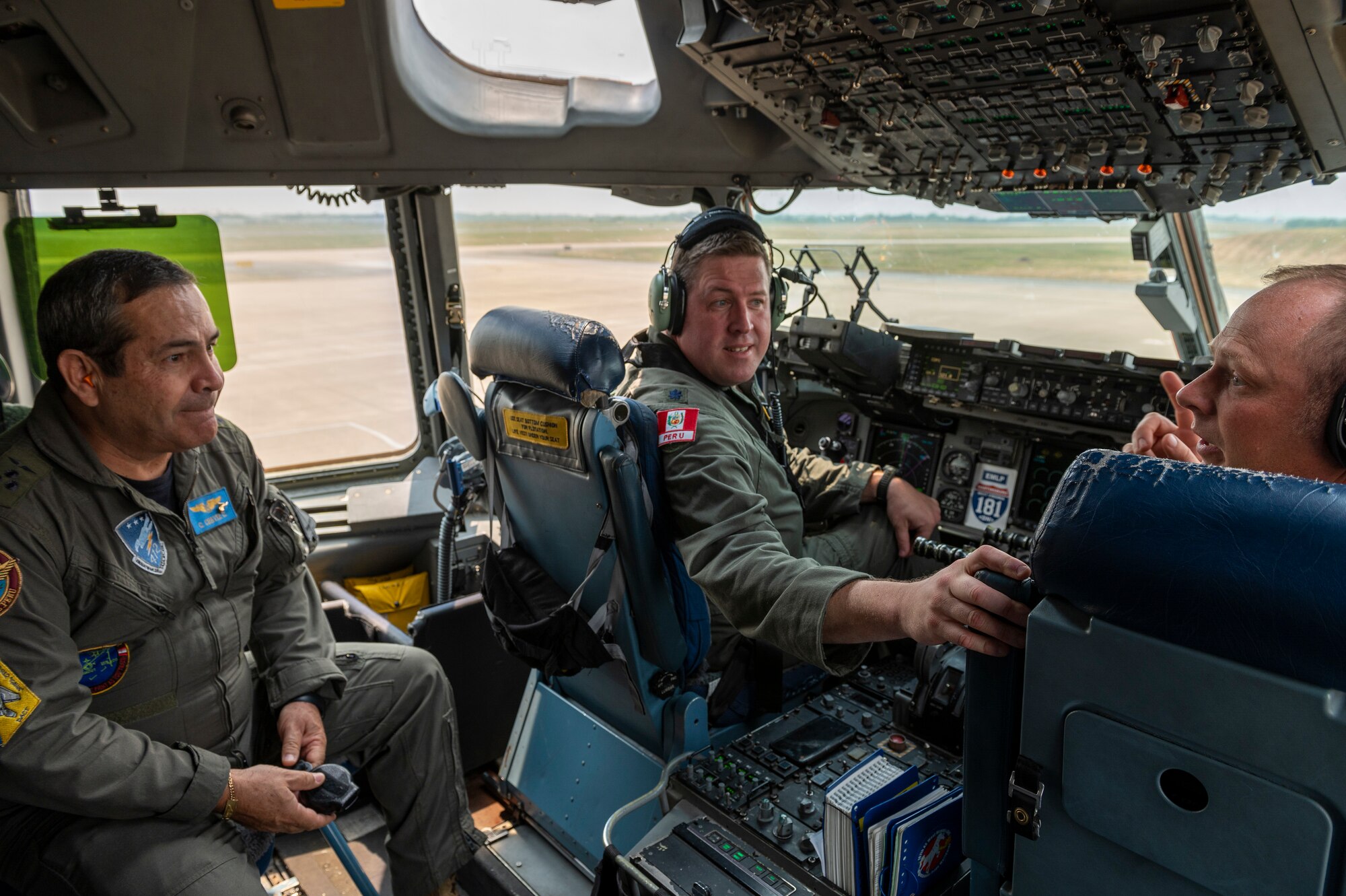Peruvian Air Force Lt. Gen. Carlos Chavez, the Peruvian Air Force Chief of Staff, talks with 167th Airlift Wing pilots, Lt. Col. Randy Wright and Maj. Trebor Taylor, prior to an orientation flight at Shepherd Field, Martinsburg, West Virginia, June 7, 2023