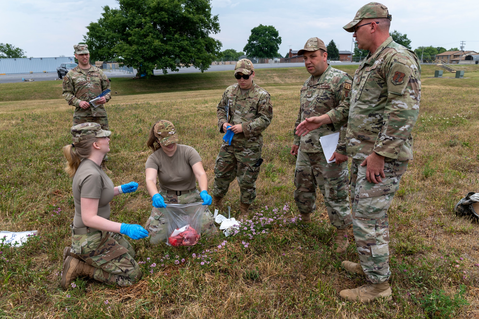 U.S. Air Force Senior Airman Charlize Wagner and Staff Sgt. Haylee Marshall, 167th Force Support Squadron services specialists, recover simulated human remains while observed by other members of 167th FSS during a search and recovery training event at the 167th Airlift Wing, Martinsburg, West Virginia, June 9, 2023.